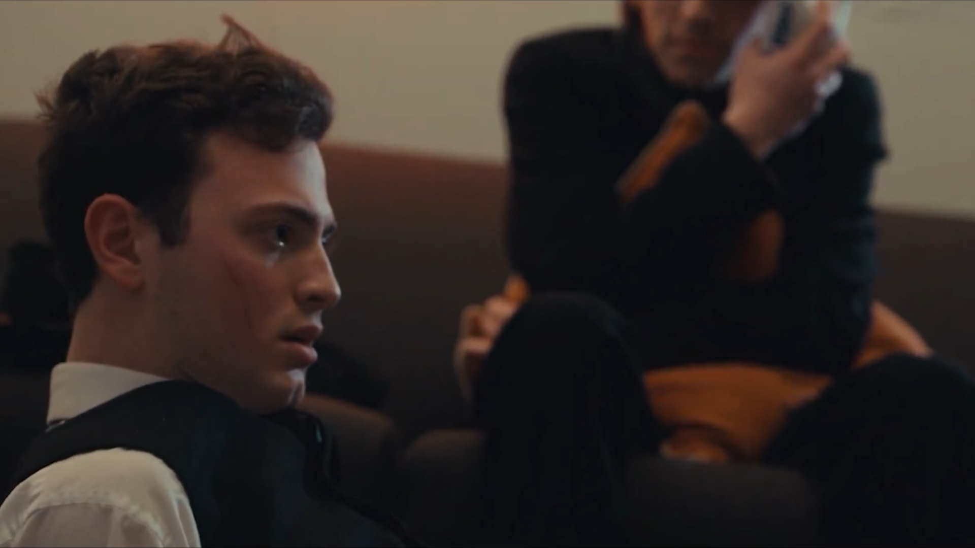 A man on the floor looking confused