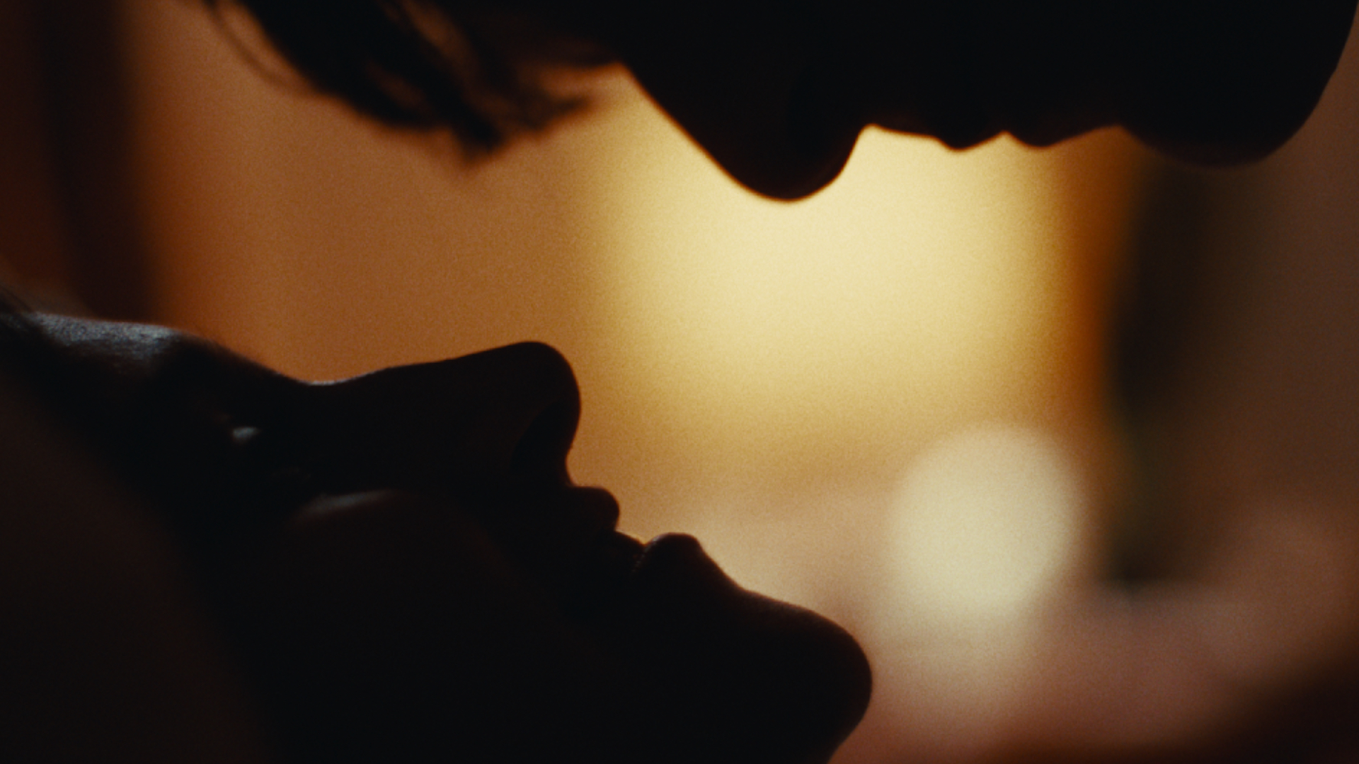 Close up shot of two characters looking at each other while laying down.